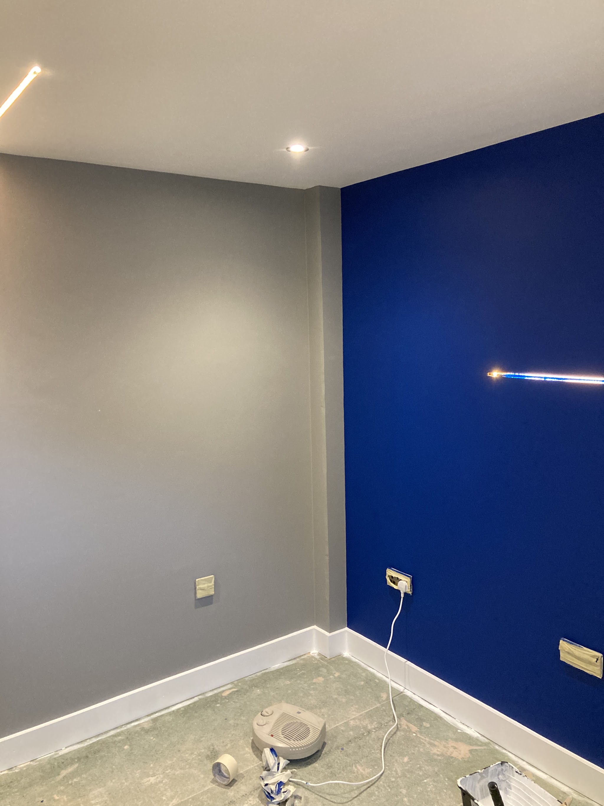 Grey room with a deep navy feature wall and fresh white skirting